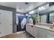 Bright bathroom with double vanity, granite counters and a large mirror at 25519 W Crown King Rd, Buckeye, AZ 85326