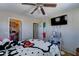 Cozy bedroom with ceiling fan, organized closet, and fun Hello Kitty themed bedding at 25519 W Crown King Rd, Buckeye, AZ 85326