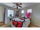 Bright bedroom with natural light, Hello Kitty bedding, shelving, and a ceiling fan at 25519 W Crown King Rd, Buckeye, AZ 85326