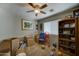 Bedroom equipped with a ceiling fan, storage shelving, natural light, and moving boxes ready to be unpacked at 25519 W Crown King Rd, Buckeye, AZ 85326