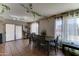 Open dining area with large windows, decorative curtains, tile floors, and hanging vine accents at 25519 W Crown King Rd, Buckeye, AZ 85326