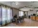 Bright dining area featuring large windows, tiled floor, hanging plants, and decorative lighting at 25519 W Crown King Rd, Buckeye, AZ 85326