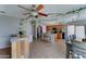 Open-concept kitchen with central island, tile flooring, wooden cabinets, and stainless steel appliances at 25519 W Crown King Rd, Buckeye, AZ 85326