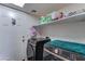 Functional laundry room featuring modern washer and dryer units and shelving for storage at 25519 W Crown King Rd, Buckeye, AZ 85326