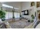 Bright living room with high ceilings, large windows, and a stylish area rug at 25519 W Crown King Rd, Buckeye, AZ 85326