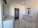 Bright bathroom featuring marble floors, double sinks, and access to a walk-in closet at 28151 N Faded Creek Dr, Florence, AZ 85132