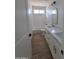 Well-lit bathroom with double vanity, quartz countertop, wood-look floors, and a shower-tub combo at 28151 N Faded Creek Dr, Florence, AZ 85132