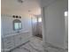 Contemporary bathroom showcasing a modern vanity, marble floors, and glass-enclosed walk-in shower at 28151 N Faded Creek Dr, Florence, AZ 85132