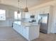 Beautiful eat-in kitchen features quartz countertops, stainless steel appliances, and large island at 28151 N Faded Creek Dr, Florence, AZ 85132