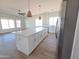Spacious open concept living and kitchen area with hard wood flooring and ample natural light at 28151 N Faded Creek Dr, Florence, AZ 85132