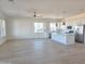 Spacious open concept living and kitchen area, featuring hard wood flooring and ample natural light at 28151 N Faded Creek Dr, Florence, AZ 85132