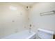 Close-up of bathtub and showerhead in bathroom with floral tiling at 3415 N 36Th St # 3, Phoenix, AZ 85018