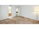 Well-lit bedroom with neutral carpet, a full bathroom and living area in the distance at 3415 N 36Th St # 3, Phoenix, AZ 85018