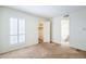 Large bedroom featuring neutral carpet, plantation shutters and ensuite bathroom at 3415 N 36Th St # 3, Phoenix, AZ 85018
