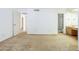 Large bedroom leading to bathroom and living room with neutral carpet at 3415 N 36Th St # 3, Phoenix, AZ 85018