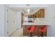 Eat-in kitchen featuring a breakfast bar with orange swivel chairs and tile flooring at 3415 N 36Th St # 3, Phoenix, AZ 85018