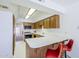 Kitchen featuring wood cabinets, tile floor and a breakfast bar with orange swivel chairs at 3415 N 36Th St # 3, Phoenix, AZ 85018