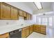 Kitchen featuring wood cabinets, white countertops, tile flooring, and stainless steel dishwasher at 3415 N 36Th St # 3, Phoenix, AZ 85018