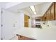 Kitchen showcasing a breakfast bar, tile flooring, wood cabinets and white appliances at 3415 N 36Th St # 3, Phoenix, AZ 85018