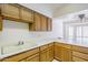 Kitchen featuring wood cabinets, white countertops, sink, and tile flooring at 3415 N 36Th St # 3, Phoenix, AZ 85018