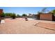 Spacious backyard featuring a fountain, covered patio, and gravel landscaping perfect for outdoor entertaining at 3507 W Oakland St, Chandler, AZ 85226