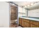 Cozy bathroom featuring a shower with glass door and light wood cabinets at 3507 W Oakland St, Chandler, AZ 85226