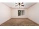 Bedroom with neutral walls, plush carpeting, ceiling fan, and a window providing natural light at 3507 W Oakland St, Chandler, AZ 85226