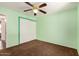 Bedroom with green walls, closet, carpet, and ceiling fan at 3507 W Oakland St, Chandler, AZ 85226