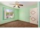 Bedroom with green walls, carpet, ceiling fan, and a window with outdoor views at 3507 W Oakland St, Chandler, AZ 85226