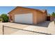 View of tan-colored single Gathering house, showing attached two-car garage and wide driveway at 3507 W Oakland St, Chandler, AZ 85226
