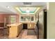 Well-equipped kitchen with a breakfast bar, stainless steel refrigerator, and modern lighting fixtures at 3507 W Oakland St, Chandler, AZ 85226