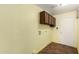 Bright laundry room with overhead cabinets, tile floors, and hookups for washer and dryer at 3507 W Oakland St, Chandler, AZ 85226