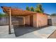 Exterior view of a shed in the backyard featuring a covered area, with a concrete slab at 3507 W Oakland St, Chandler, AZ 85226