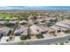 Expansive aerial view of a neighborhood with many single-Gathering homes, solar panels, and desert landscaping at 37460 W Giallo Ln, Maricopa, AZ 85138
