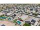 Aerial view showing a fenced-in neighborhood with swimming pools and desert landscaping at 37460 W Giallo Ln, Maricopa, AZ 85138
