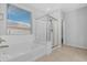 Bright bathroom features a soaking tub, glass shower, and large window for natural light at 37460 W Giallo Ln, Maricopa, AZ 85138