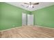 Bedroom with wood-look floors, ceiling fan and two doors at 37460 W Giallo Ln, Maricopa, AZ 85138