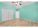 Bedroom with wood-look floors and double door closet at 37460 W Giallo Ln, Maricopa, AZ 85138
