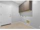 Laundry room with storage cabinet and white door at 37460 W Giallo Ln, Maricopa, AZ 85138