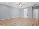 Spacious main bedroom with wood-look flooring, ensuite bathroom access at 37460 W Giallo Ln, Maricopa, AZ 85138