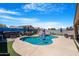 Sparkling in-ground pool with waterfall feature, slide, and hot tub at 37460 W Giallo Ln, Maricopa, AZ 85138