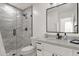 Modern bathroom features a gray-tiled shower, white vanity, and a sleek black framed mirror at 389 W Fairway Pl, Chandler, AZ 85225