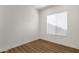 Simple bedroom design with wood-look vinyl floors, a white wall, and a window with blinds at 389 W Fairway Pl, Chandler, AZ 85225
