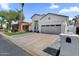 Inviting single-story home with a large driveway, well-kept lawn, and contemporary architectural style at 389 W Fairway Pl, Chandler, AZ 85225