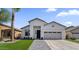 Charming single-story home featuring a well-manicured lawn, modern architectural details, and a welcoming entrance at 389 W Fairway Pl, Chandler, AZ 85225