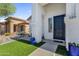 Welcoming front porch with artificial turf, decorative blue planters, and a cozy entrance to the home at 389 W Fairway Pl, Chandler, AZ 85225