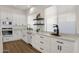 Modern kitchen with white cabinets, quartz countertops, floating shelves and updated appliances at 389 W Fairway Pl, Chandler, AZ 85225