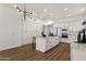 Bright kitchen featuring a large island, abundant storage, modern lighting, and updated appliances at 389 W Fairway Pl, Chandler, AZ 85225