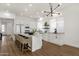Stylish kitchen island with seating, complemented by white cabinetry and modern light fixtures at 389 W Fairway Pl, Chandler, AZ 85225