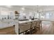Modern kitchen with island, bar seating, farm sink, and ample natural light; open concept design at 389 W Fairway Pl, Chandler, AZ 85225